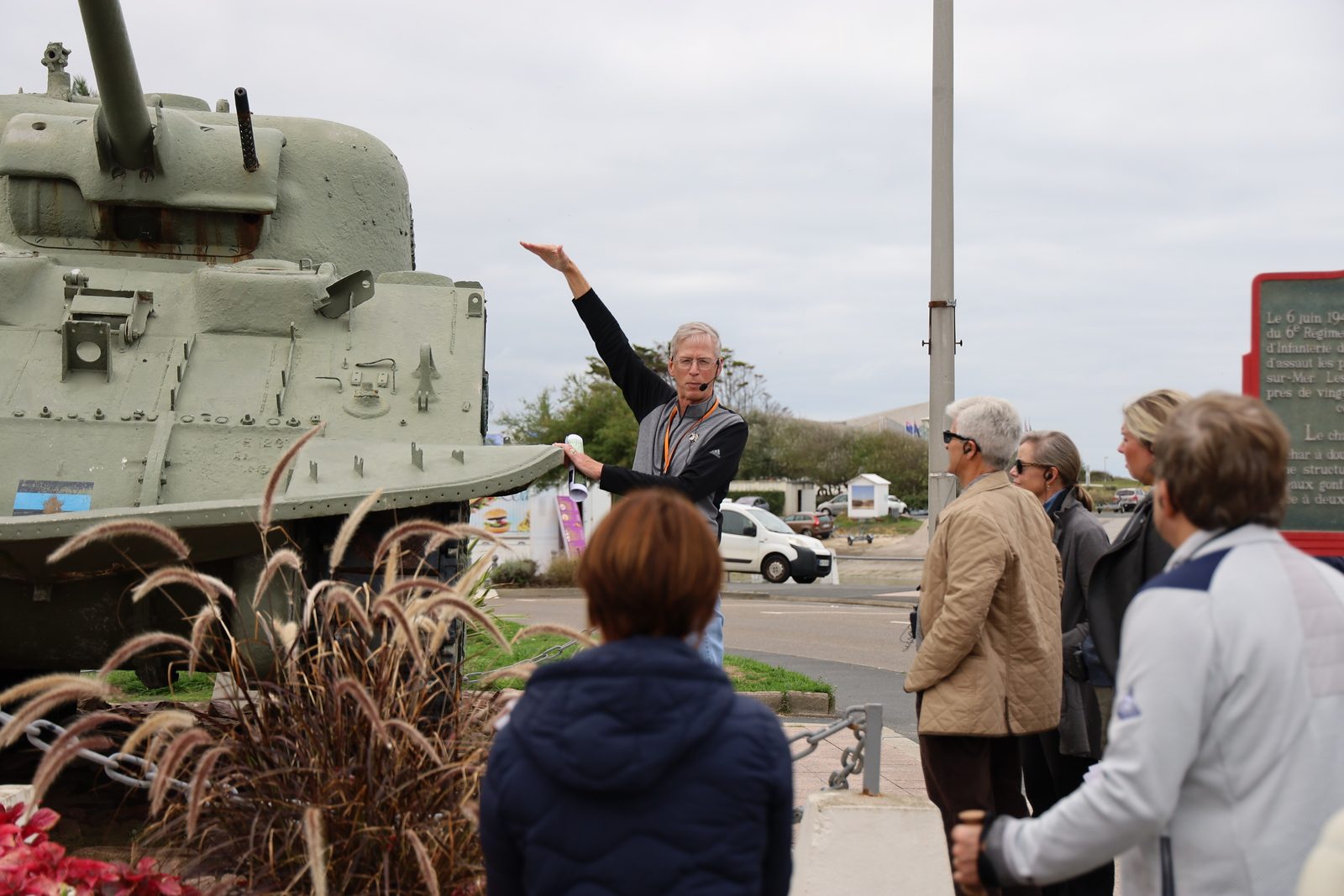 Kevin leading a tour beside a Sherman DD tank in Normandy