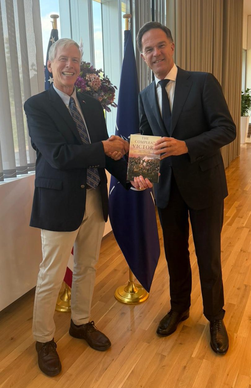 Kevin Weddle presenting a copy of The Compleat Victory to NATO Secretary General Mark Rutte